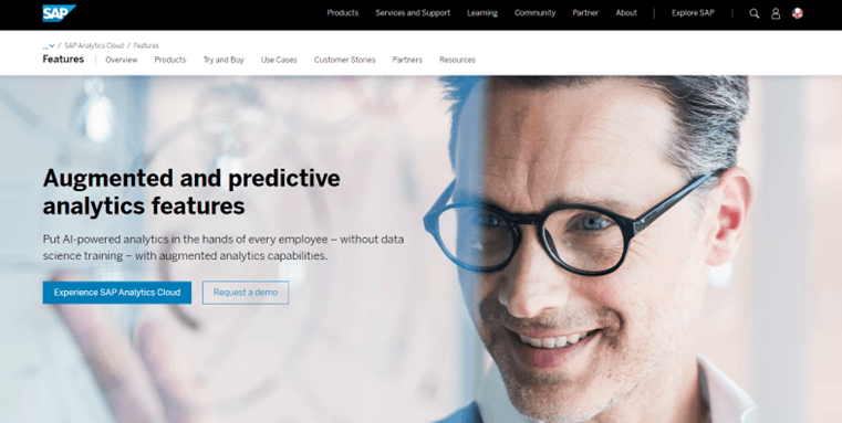 A website page for SAP Analytics Cloud features a smiling man in glasses, with text promoting augmented and predictive analytics and exploring applications of AI. Blue buttons offer options to experience or request a demo of SAP Analytics Cloud.