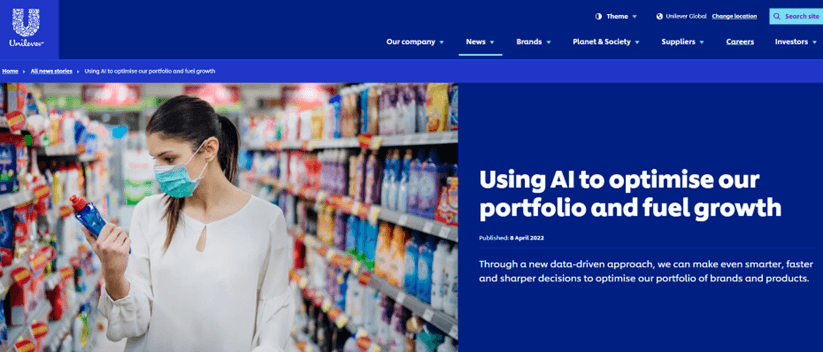A woman wearing a mask examines a product in a brightly lit shop aisle, with shelves stocked with various items. The screen displays a headline about using applications of AI to optimise Unilever’s portfolio and fuel growth.