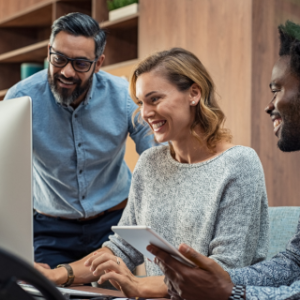 People looking at laptop smiling