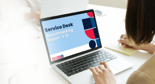 women on laptop reading benchmarking report