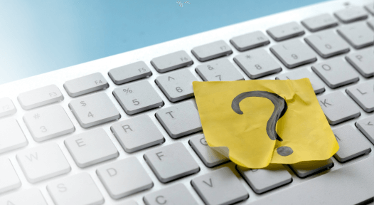 a note with question mark on the keyboard